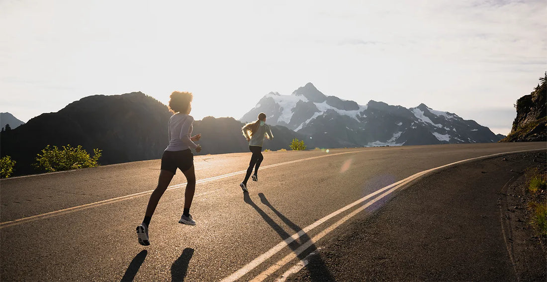 Two people running on road wearing Superfeet insoles and shoe inserts